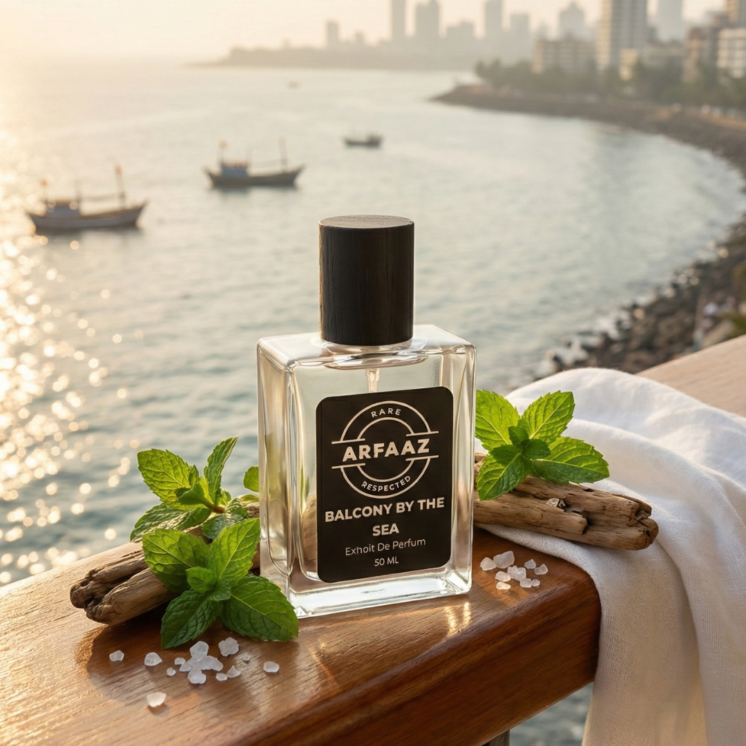 Perfume bottle labeled 'Arfaaz' on a balcony with a cityscape and sea water in the background